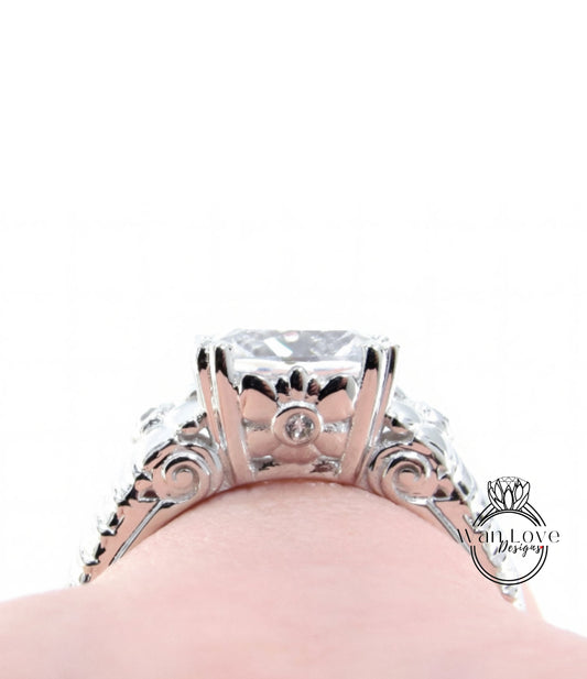 A close-up view of a silver engagement ring with a large central diamond surrounded by smaller diamonds and intricate metalwork.