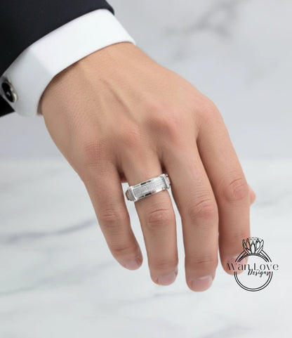 A close-up of a person's hand wearing a silver ring on the ring finger.