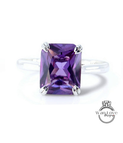 A ring with a large, purple gemstone, likely an amethyst, set in a silver band.