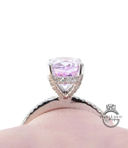 A close-up view of a diamond engagement ring with a large, clear gemstone set in a silver band.