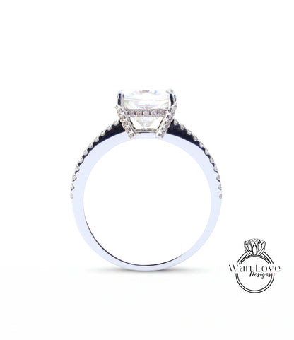 A close-up view of a diamond engagement ring with a large central diamond and smaller diamonds around the band.