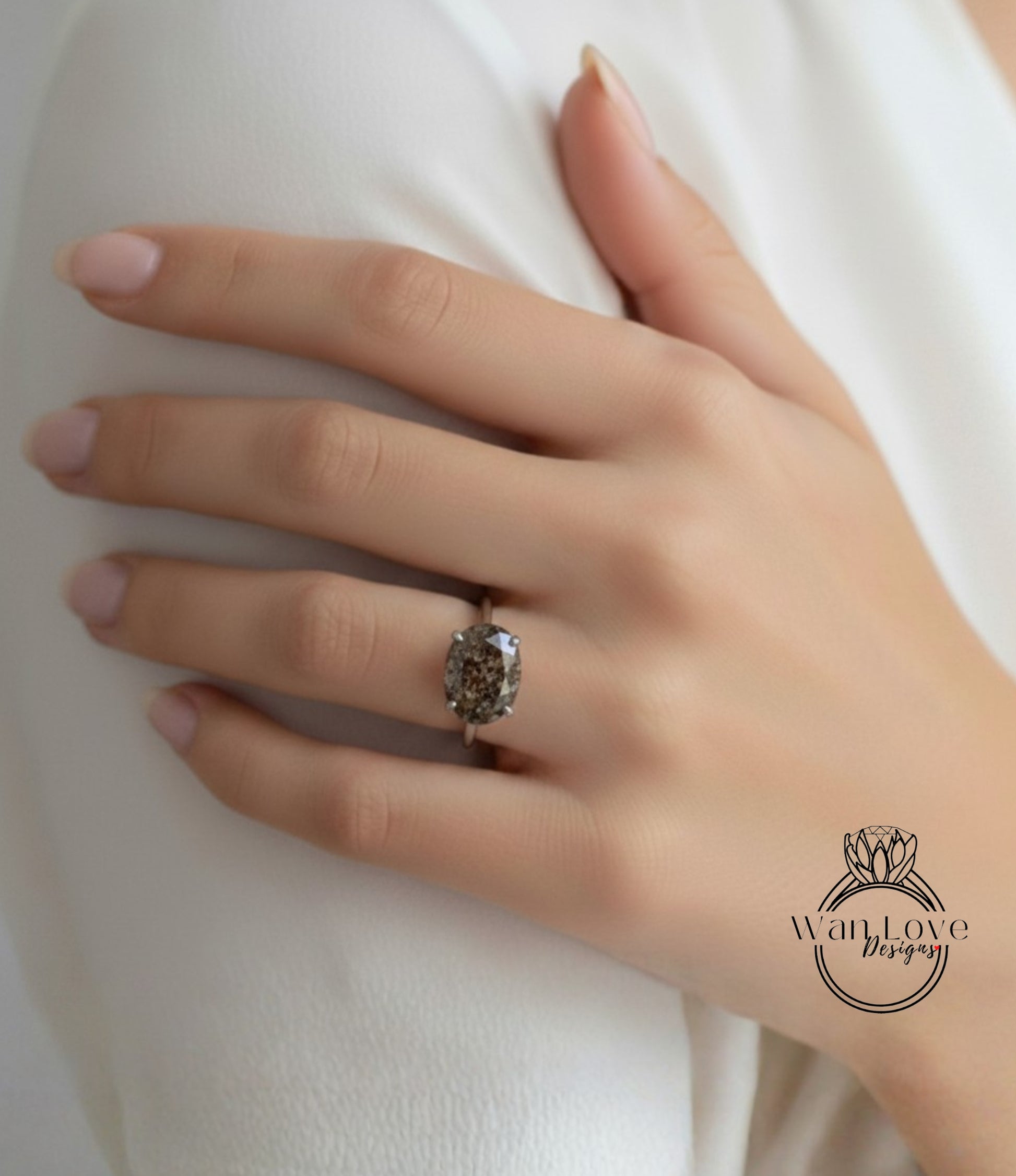 A close-up of a person's hand wearing a ring with a large, dark stone.