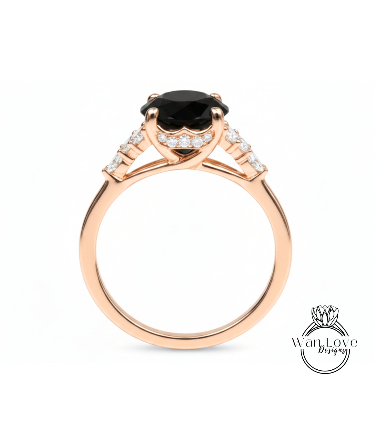 A gold ring with a large black gemstone, possibly a diamond, set in the center.