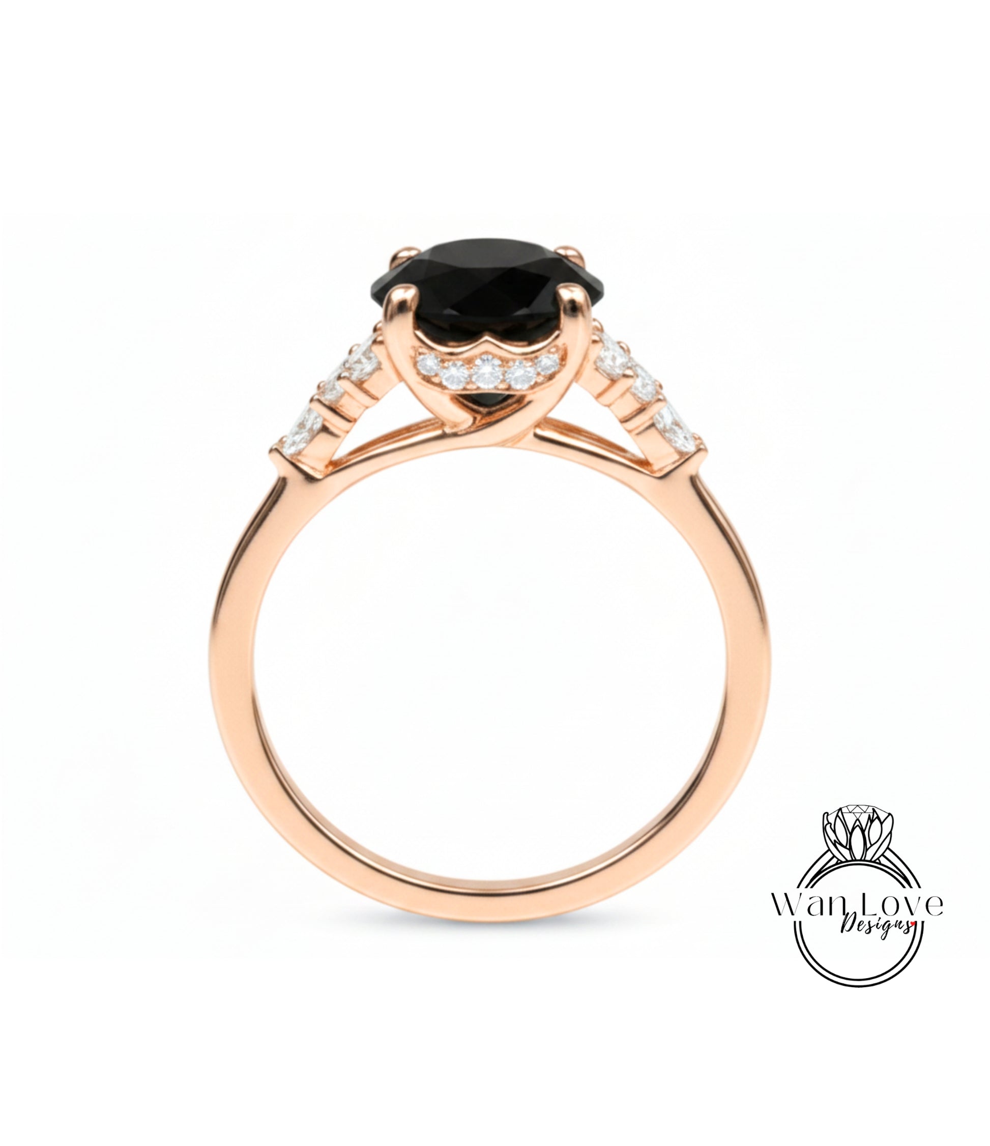 A gold ring with a large black gemstone, possibly a diamond, set in the center.