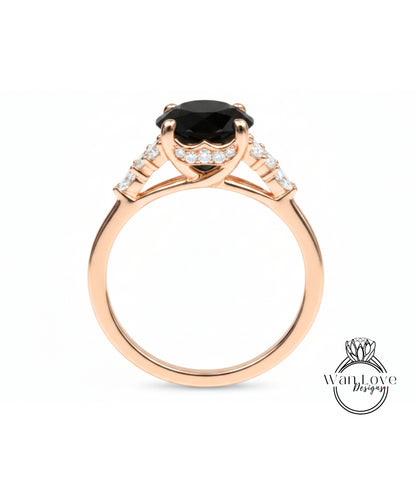 A gold ring with a large black gemstone, possibly a diamond, set in the center.