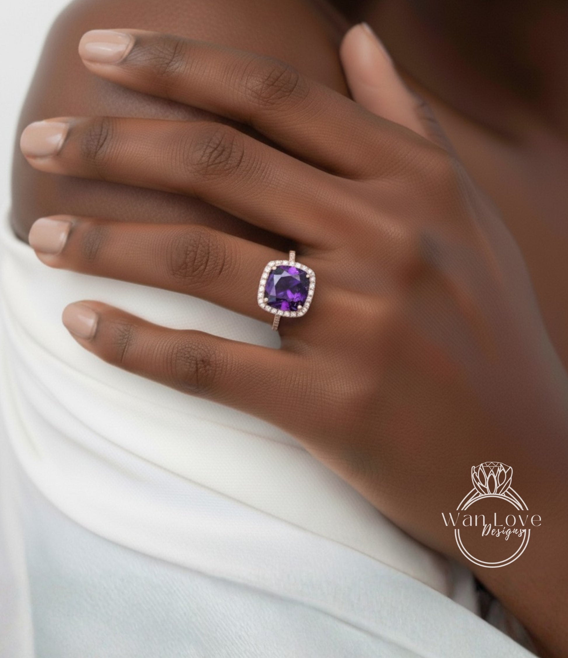 A close-up of a person's hand wearing a ring with a large purple gemstone.
