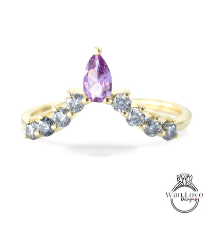 A gold ring with a large purple gemstone at the center, surrounded by smaller diamonds.