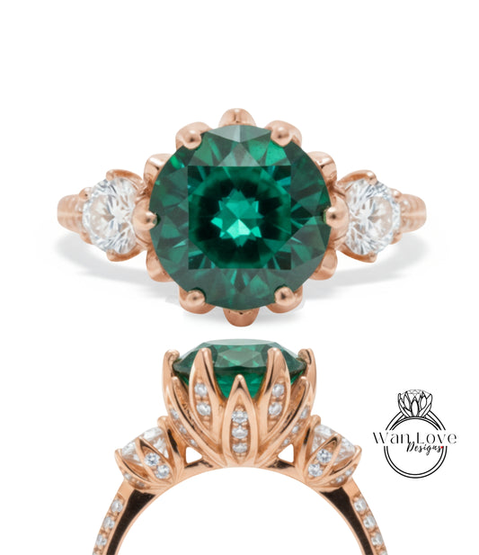 a beautiful engagement ring with a large, green gemstone set in a rose gold band. The ring is adorned with smaller diamonds and has a delicate floral design around the gemstone.
