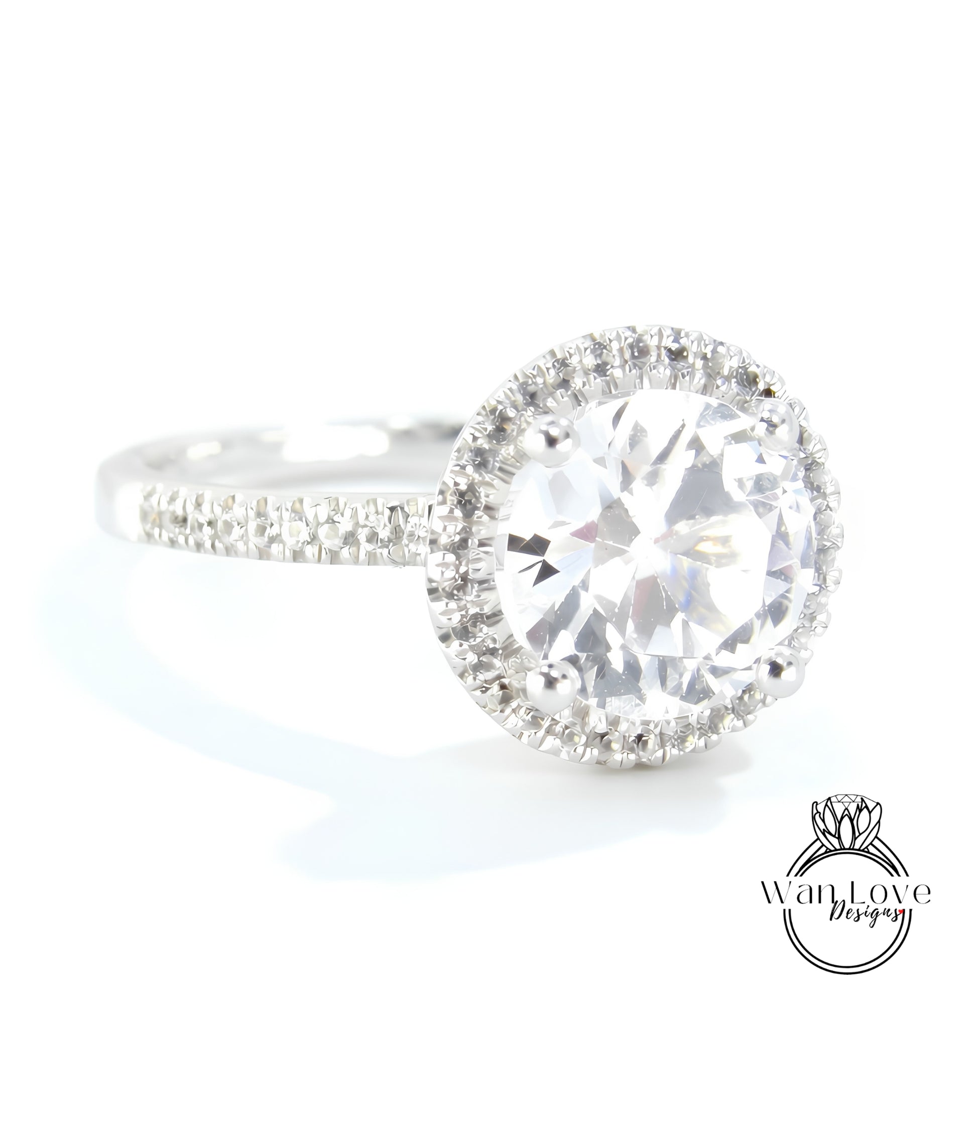 A close-up view of a diamond engagement ring with a large, round brilliant cut diamond set in a halo of smaller diamonds.