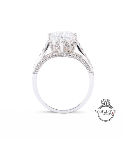 A close-up view of a diamond engagement ring with a large central diamond surrounded by smaller diamonds set in a silver band.