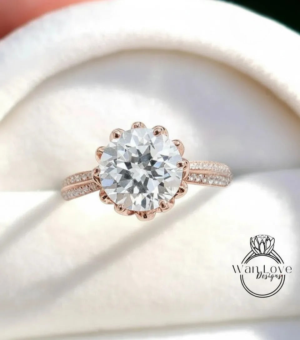 A close-up of a beautiful diamond engagement ring with a large round brilliant cut diamond set in a rose gold band.