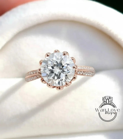 A close-up of a beautiful diamond engagement ring with a large round brilliant cut diamond set in a rose gold band.