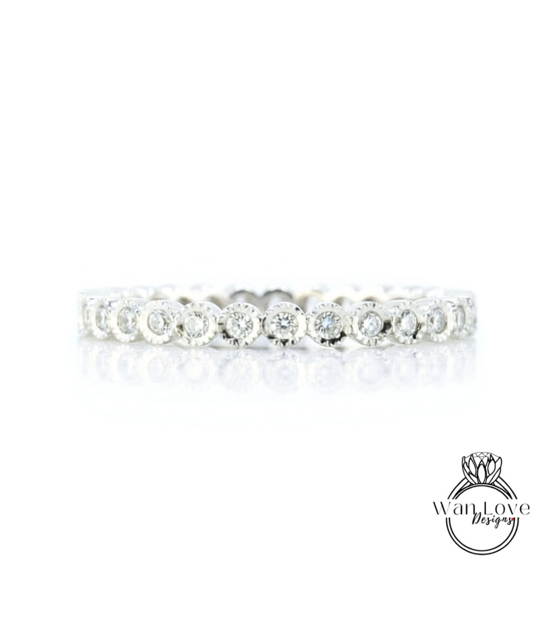 A diamond-encrusted ring with a row of small diamonds set in a silver band.