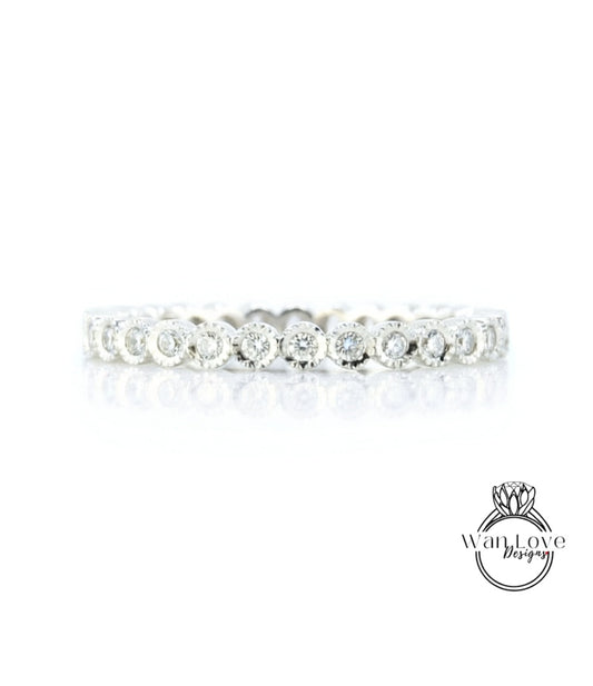 A diamond-encrusted ring with a row of small diamonds set in a silver band.
