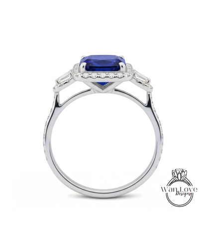 A silver ring with a large blue gemstone, likely a sapphire, set in a halo of smaller diamonds.