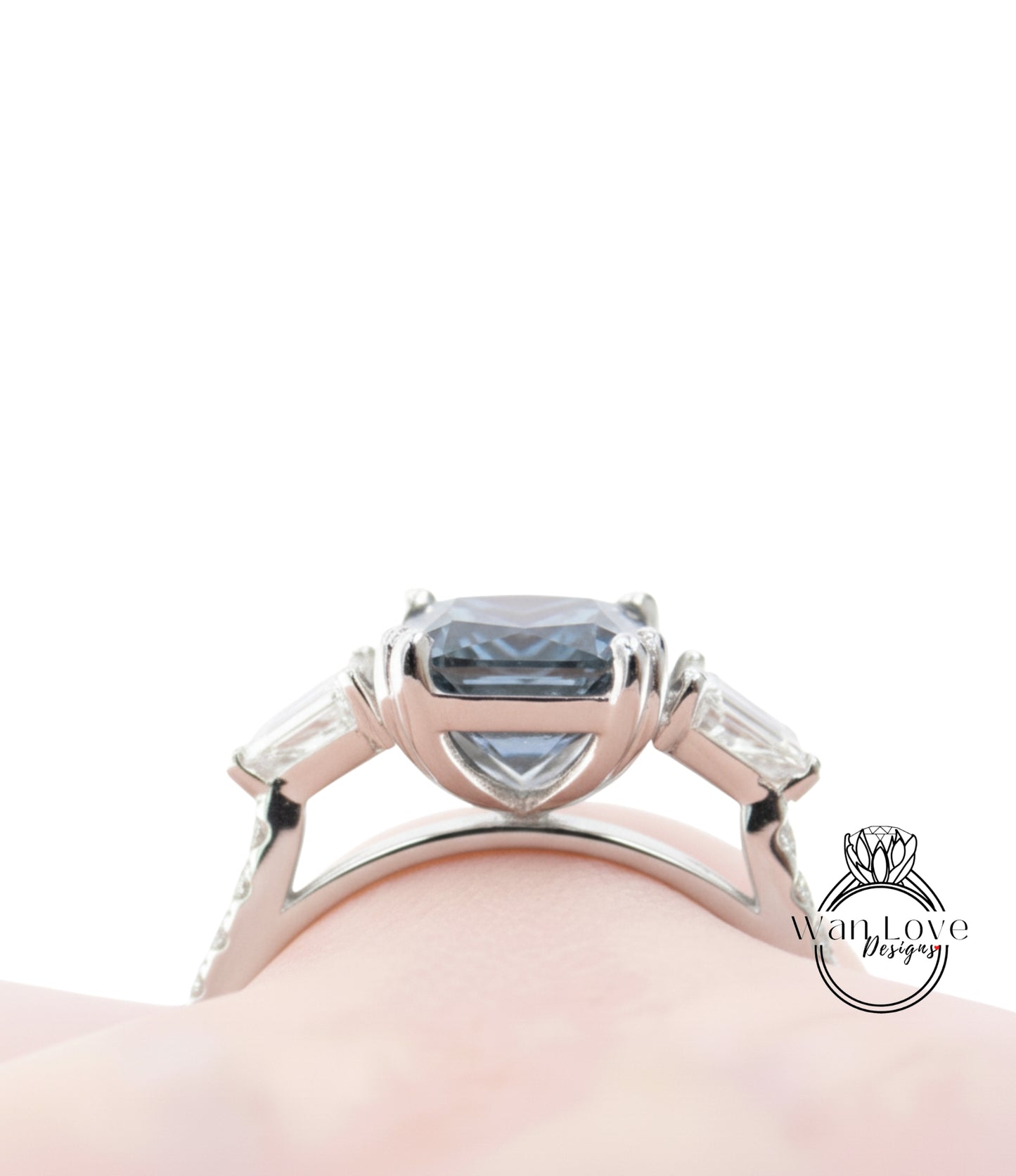 A close-up view of a silver ring with a large blue gemstone, showcasing the intricate design and craftsmanship of the piece.
