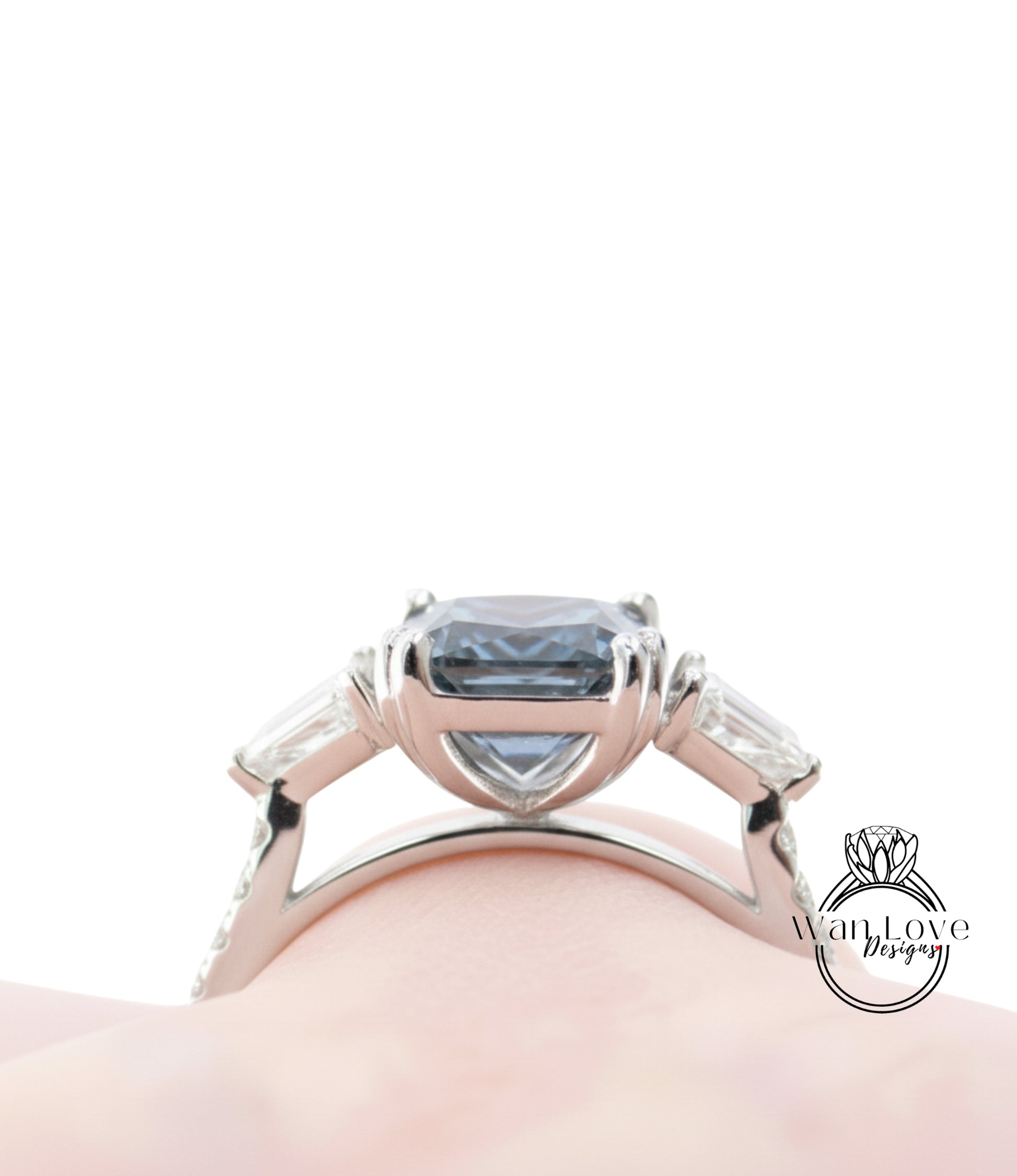 A close-up view of a silver ring with a large blue gemstone, showcasing the intricate design and craftsmanship of the piece.