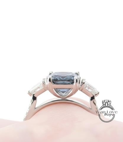 A close-up view of a silver ring with a large blue gemstone, showcasing the intricate design and craftsmanship of the piece.