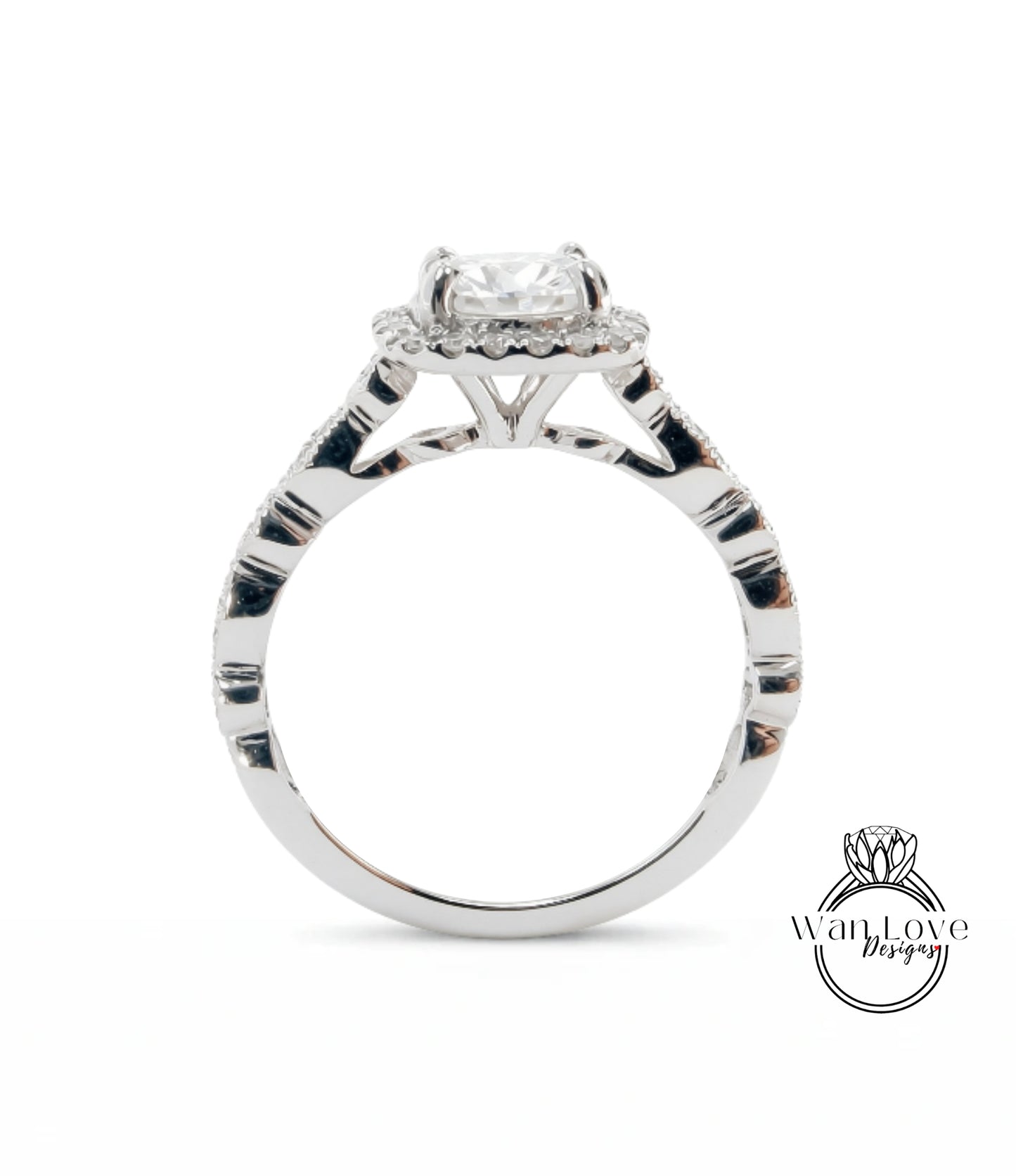 A close-up view of a silver engagement ring with a large central diamond surrounded by smaller diamonds.