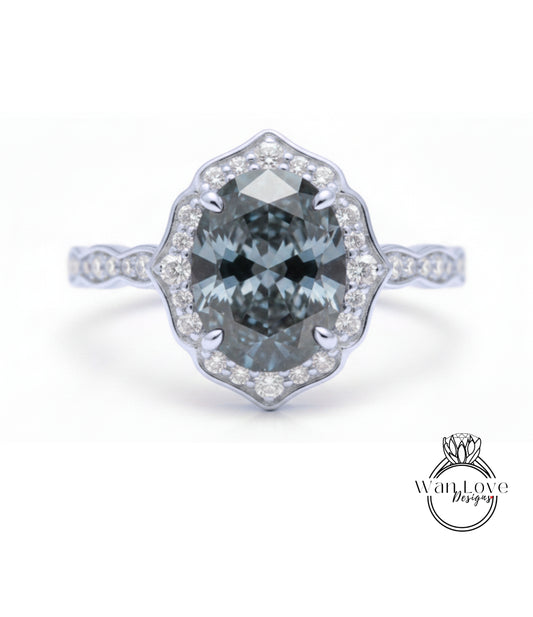A silver ring with a large oval-shaped blue gemstone set in a halo of smaller diamonds.