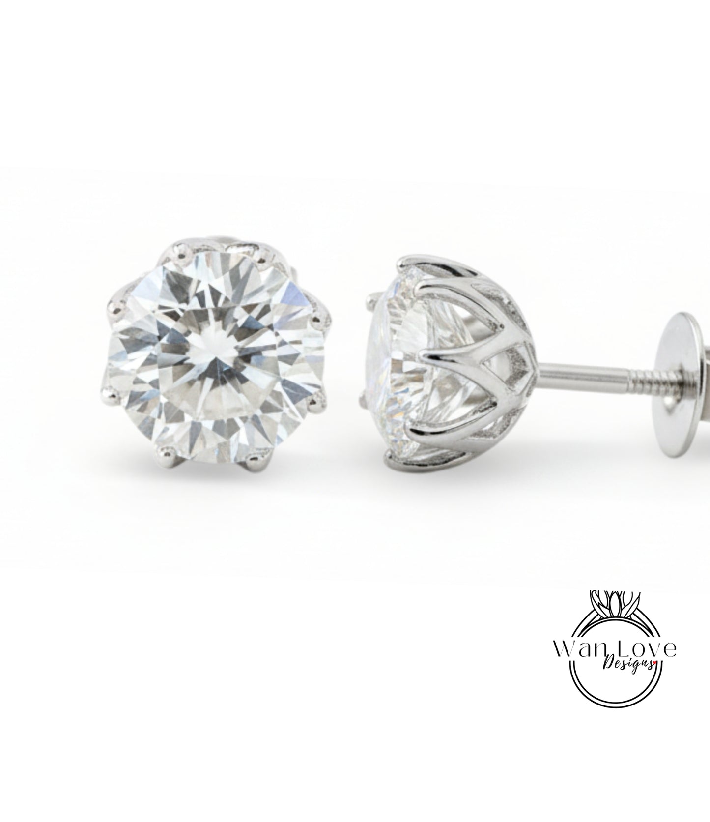 A pair of elegant diamond earrings with a large, brilliant-cut diamond set in a silver metal frame.