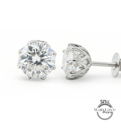 A pair of elegant diamond earrings with a large, brilliant-cut diamond set in a silver metal frame.