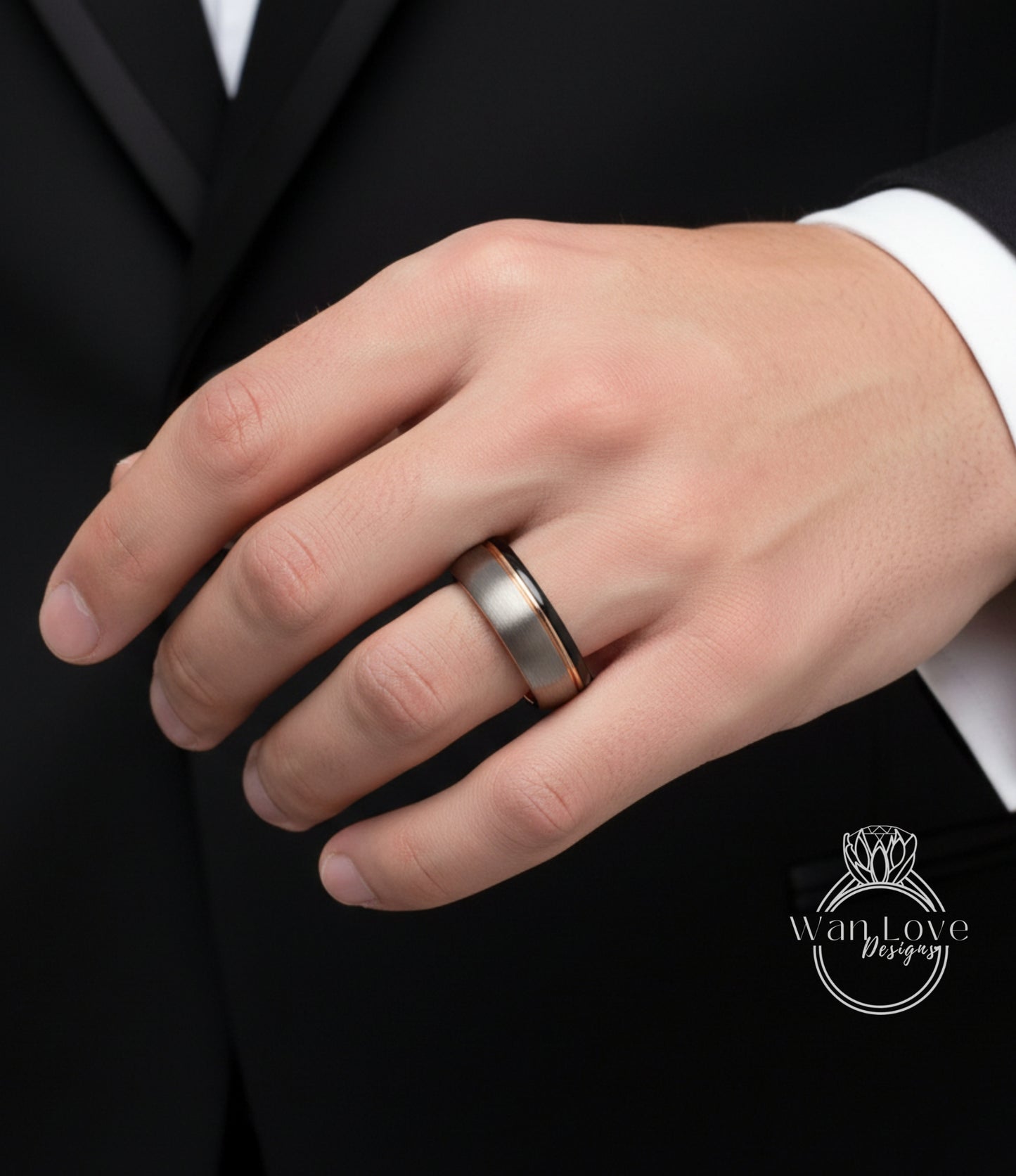A close-up of a person's hand wearing a silver ring on the ring finger.