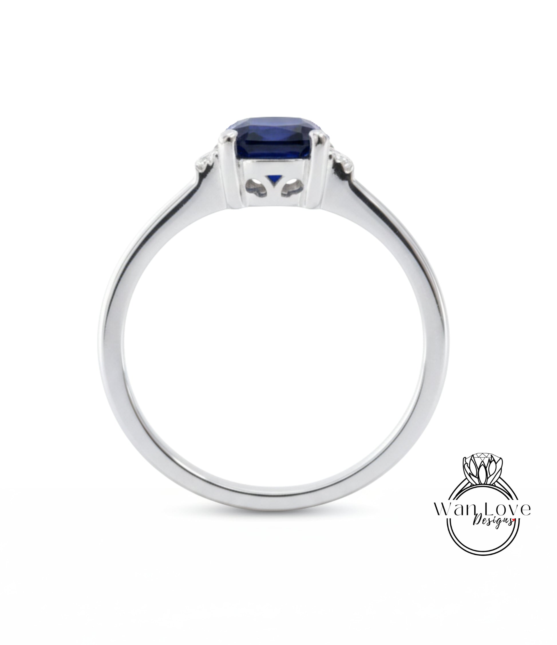 A silver ring with a blue gemstone, possibly a sapphire, set in the center.