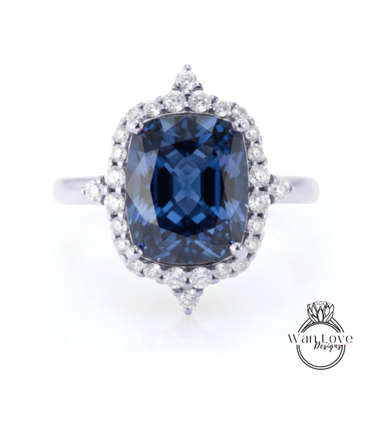 A stunning blue gemstone ring with a halo of sparkling diamonds around the center stone.