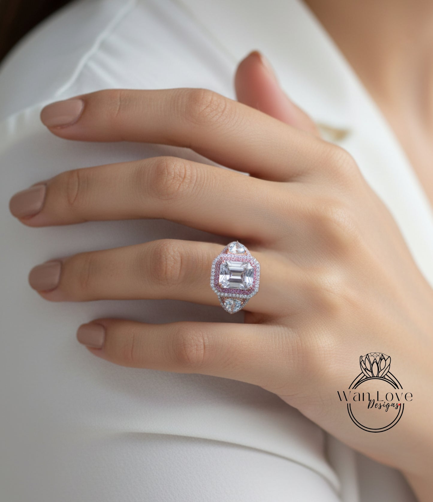 A close-up of a person's hand wearing a large, ornate ring with a pink gemstone.