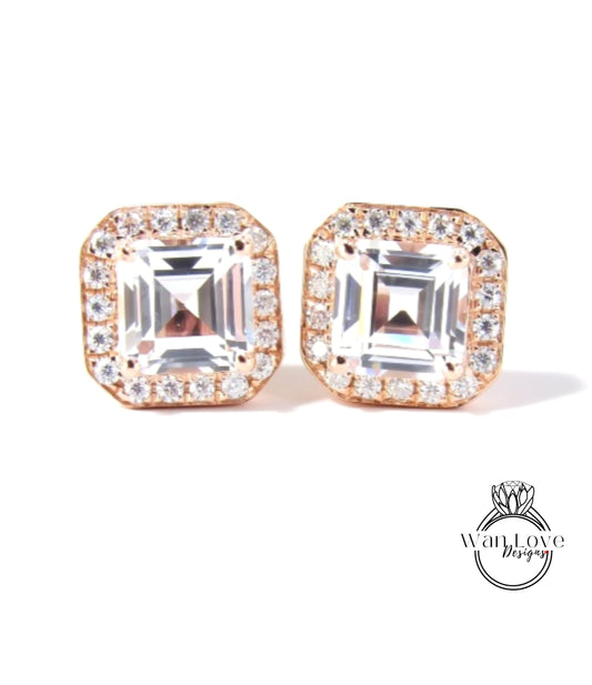 A pair of elegant earrings with large, clear gemstones set in a gold-toned metal frame.