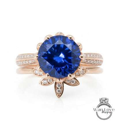 A close-up image of a gold ring with a large blue gemstone at the center, surrounded by smaller diamonds.