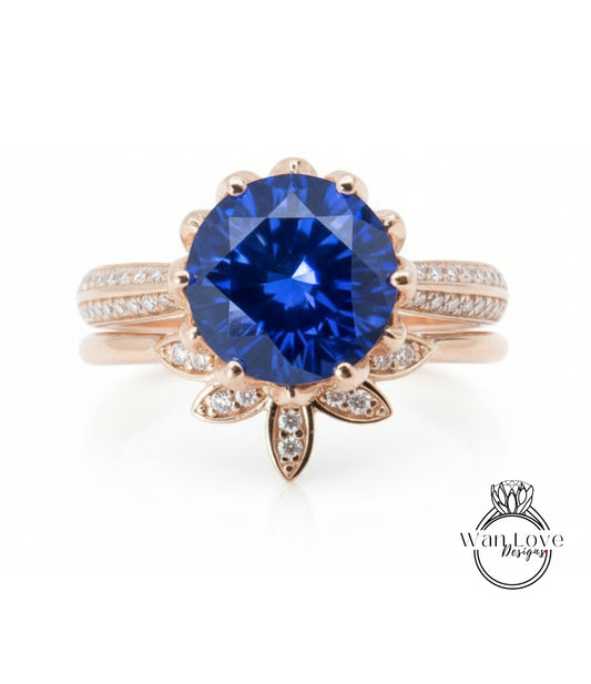 A close-up image of a gold ring with a large blue gemstone at the center, surrounded by smaller diamonds.