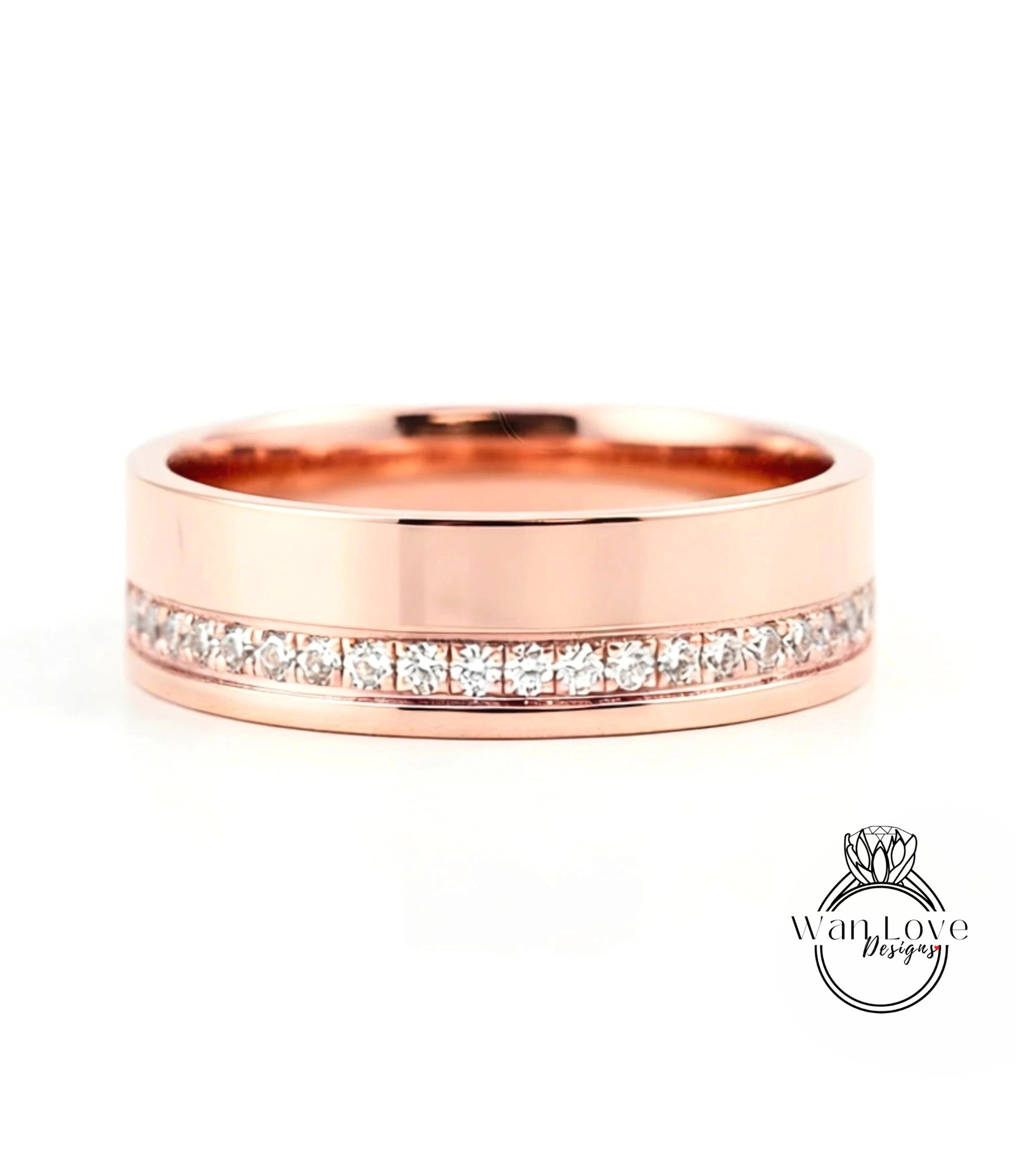 A rose gold wedding band with a row of diamonds set along the inside edge.