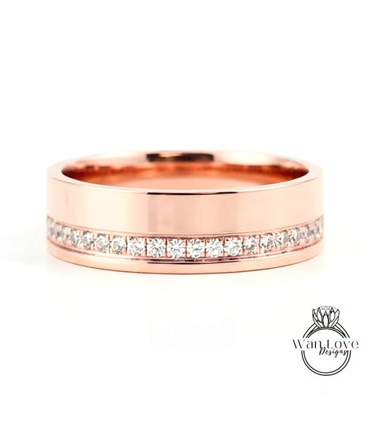 A rose gold wedding band with a row of diamonds set along the inside edge.