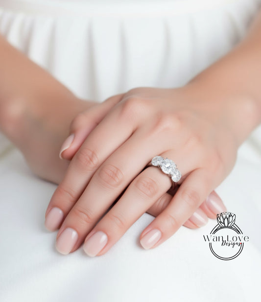 A close-up of a person's hands wearing a diamond ring.