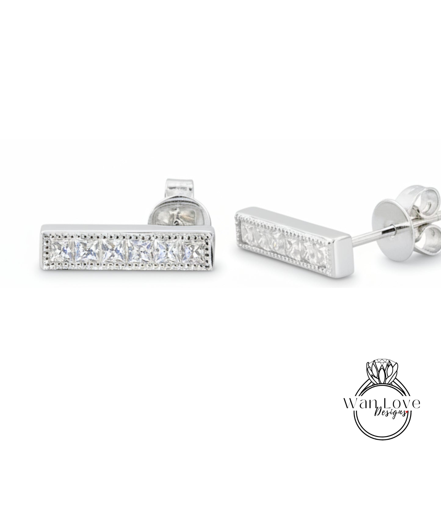 A pair of silver earrings with a row of small diamonds along the length of the bar.