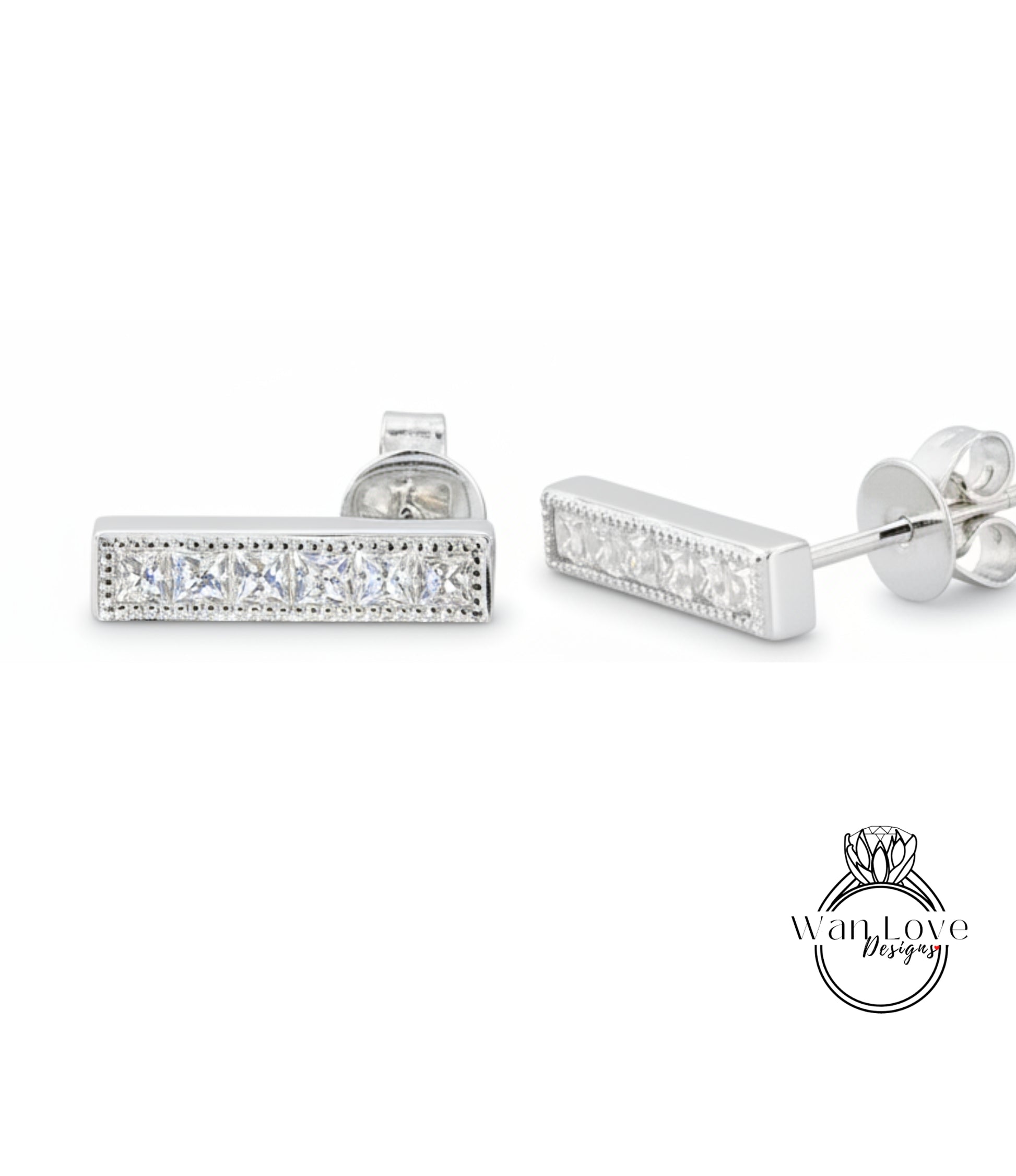 A pair of silver earrings with a row of small diamonds along the length of the bar.