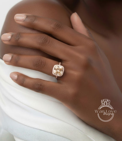 A close-up of a person's hand wearing a large, yellow diamond engagement ring on the ring finger.
