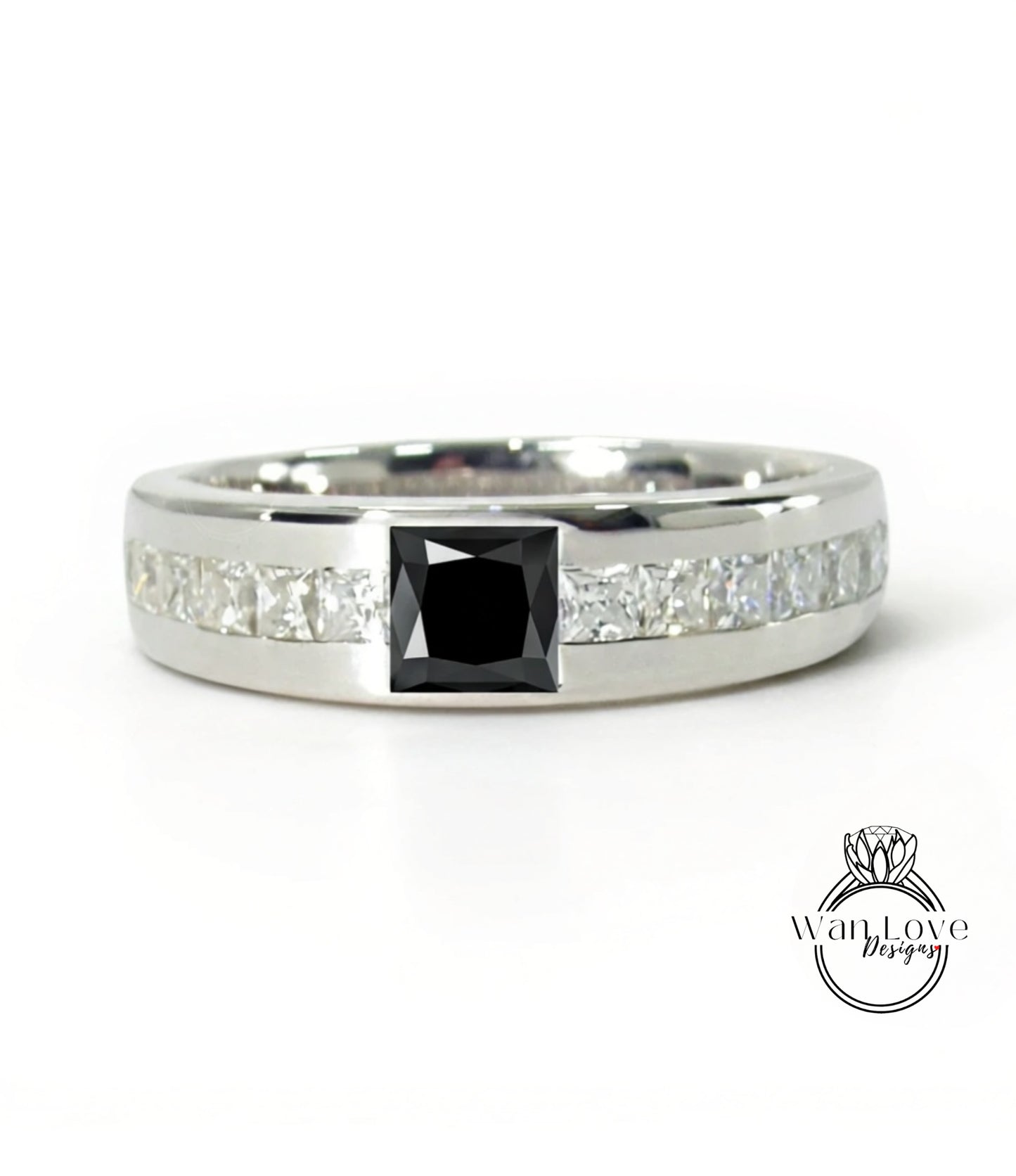 A silver ring with a large black diamond in the center, surrounded by smaller diamonds.