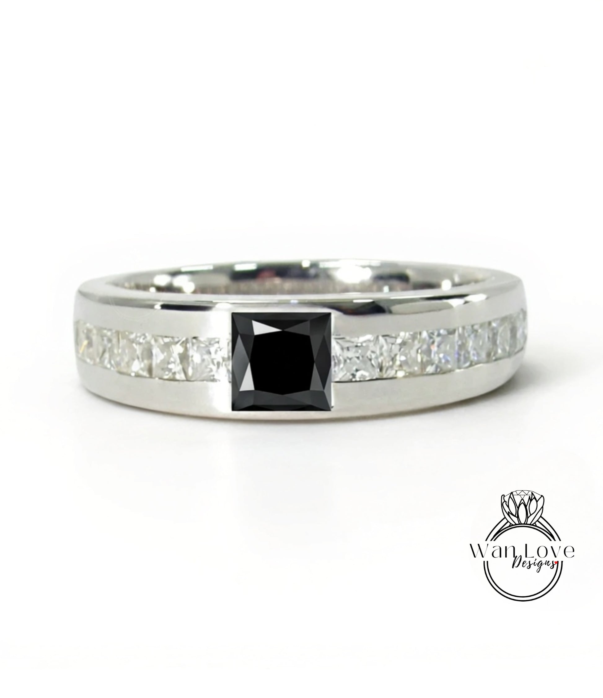 A silver ring with a large black diamond in the center, surrounded by smaller diamonds.