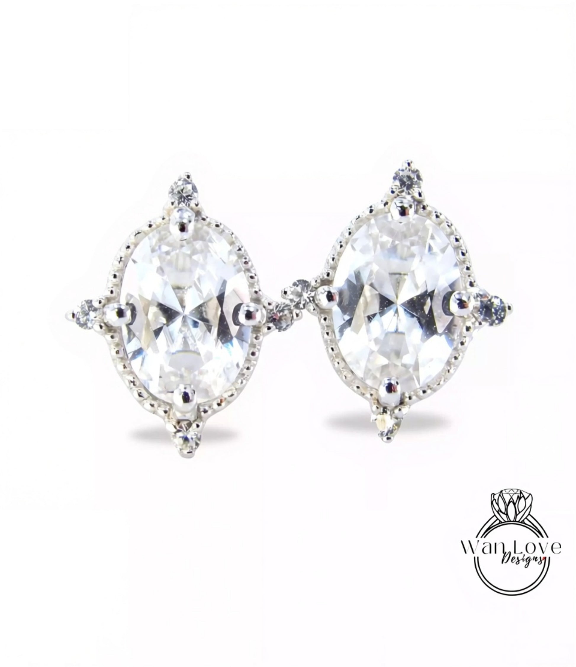 A pair of elegant earrings with large, clear gemstones set in a decorative metal frame.