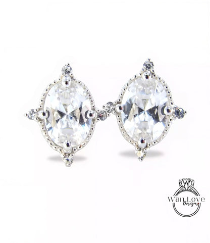 A pair of elegant earrings with large, clear gemstones set in a decorative metal frame.