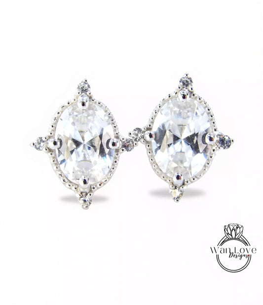 A pair of elegant earrings with large, clear gemstones set in a decorative metal frame.