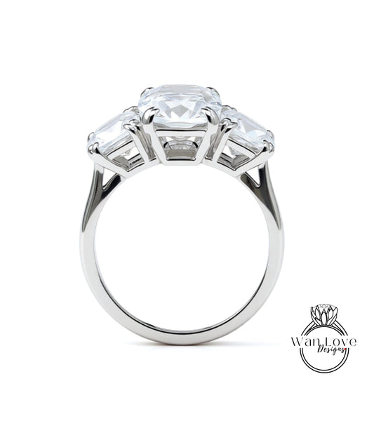 A silver ring with a large central diamond surrounded by three smaller diamonds on either side.
