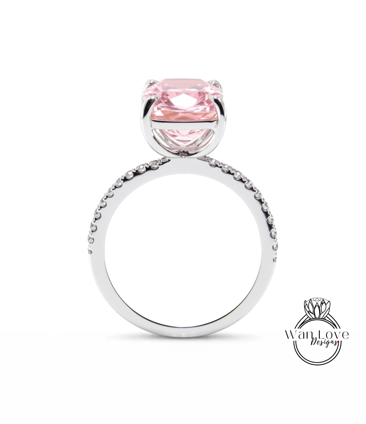 A silver ring with a large pink gemstone, likely a diamond, set in the center.