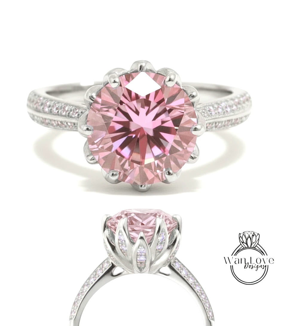 A stunning pink diamond engagement ring with a large central gemstone surrounded by smaller diamonds set in a silver band.