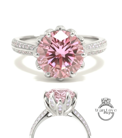 A stunning pink diamond engagement ring with a large central gemstone surrounded by smaller diamonds set in a silver band.