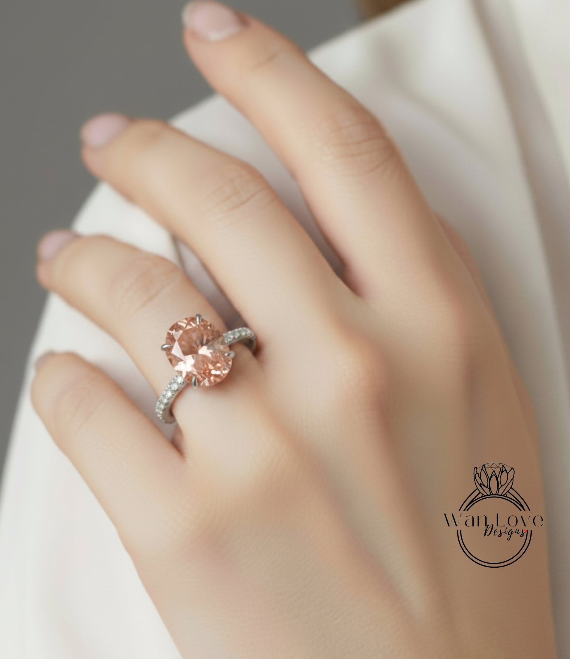 A close-up of a person's hand wearing a large, oval-shaped pink diamond engagement ring.