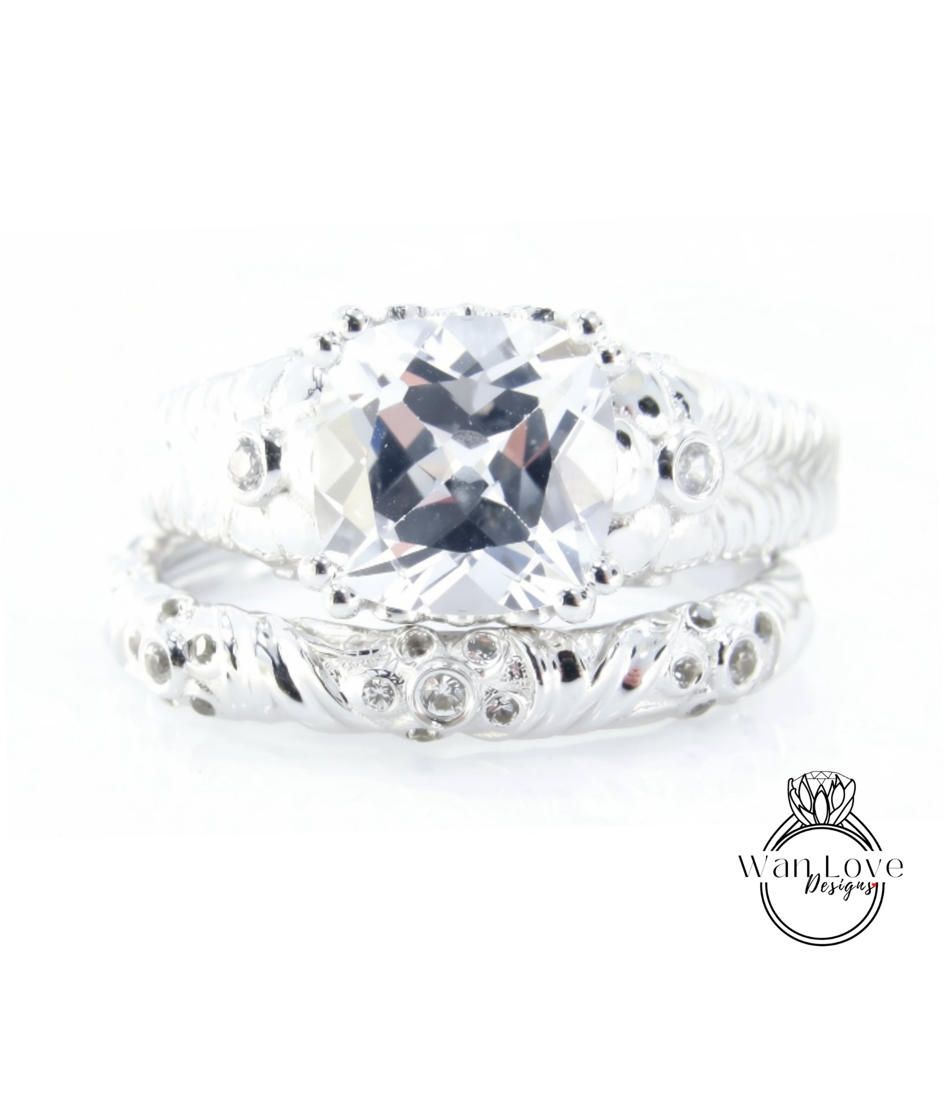 A close-up image of a silver ring with a large, clear gemstone set in the center.